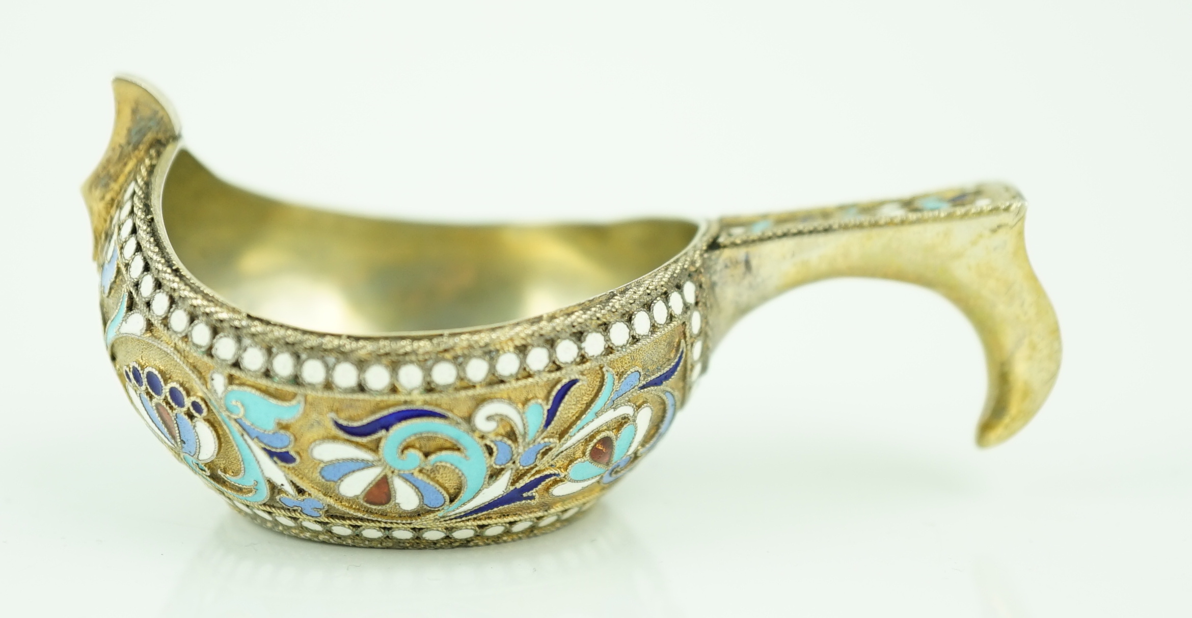 A late 19th/early 20th century Russian 84 zolotnik silver gilt and polychrome enamelled kovsh